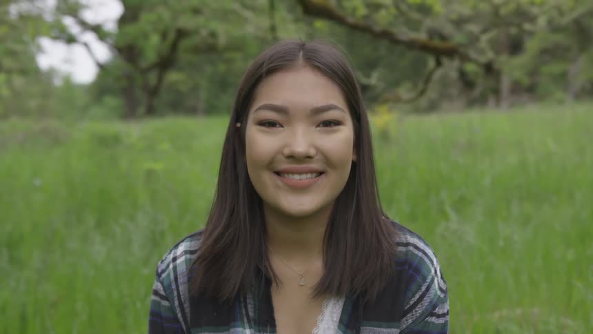 Asian woman looks into camera