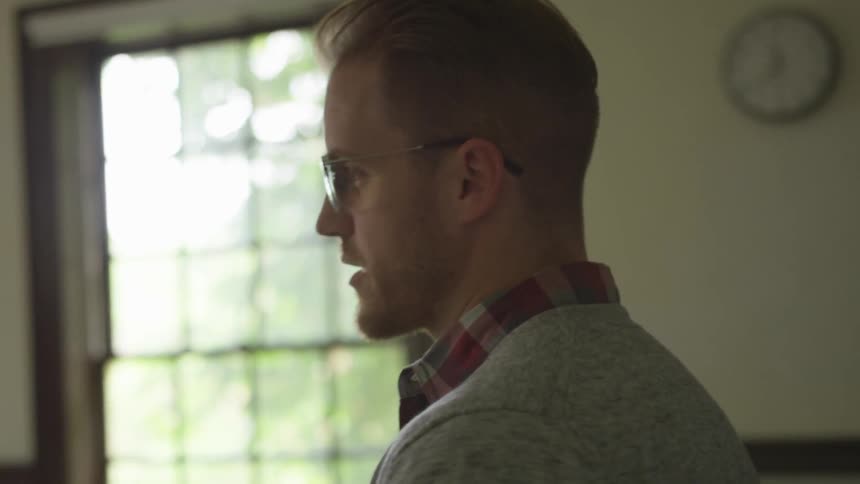 Man stands in classroom talking