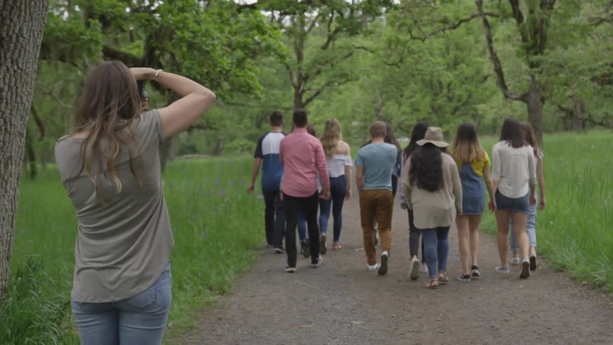 A woman taking the picture of a group of people