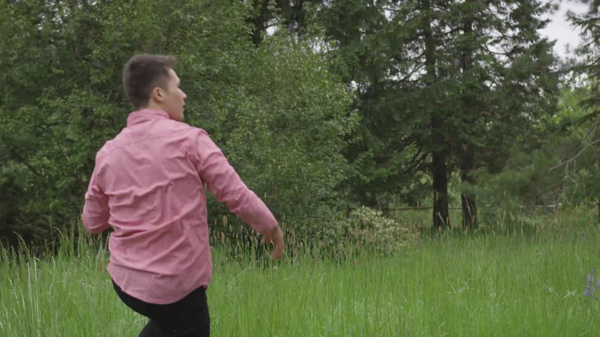 Man playing frisbee on a field of grass