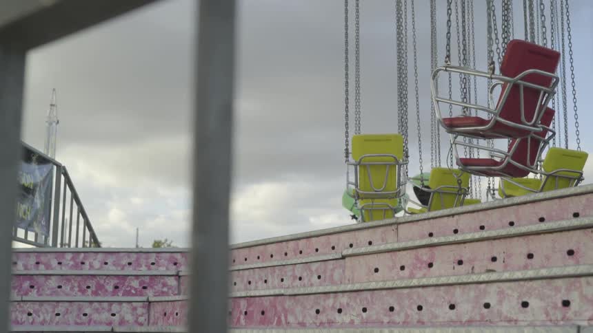 Swings of chair o plane swing in the air in amusement park on a cloudy day