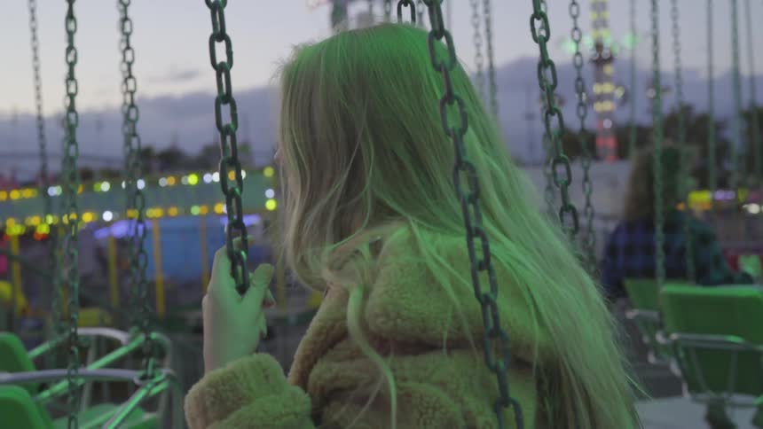 A woman on a swing ride at a carnival