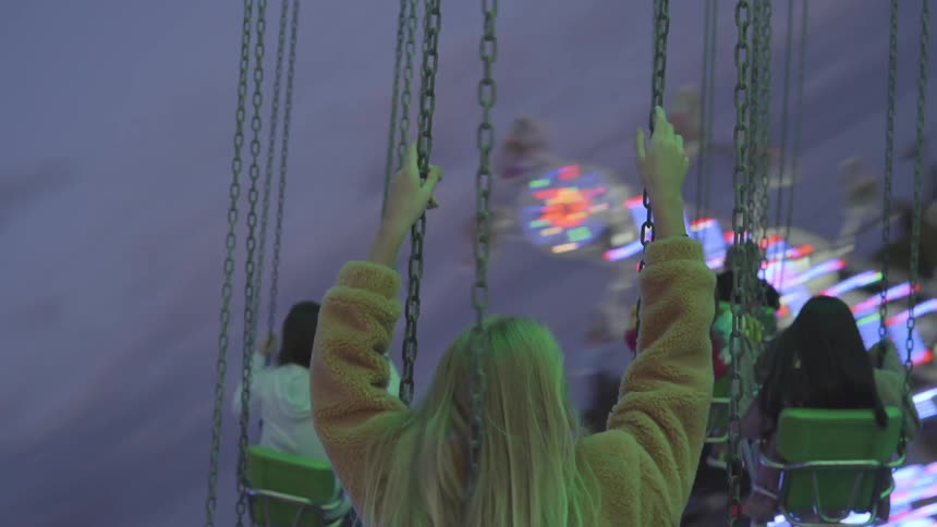 A group of people on a carnival swing