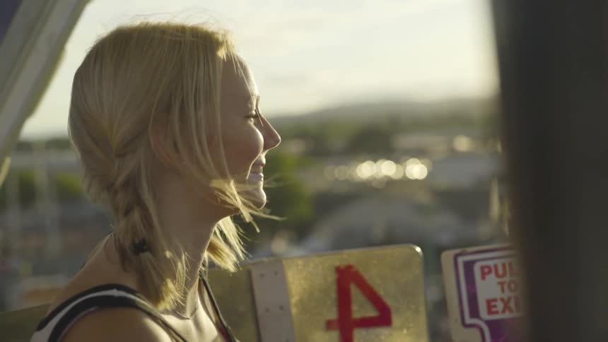 Girl rides on ferris wheel