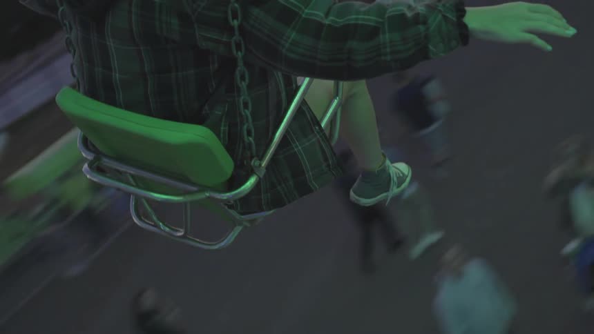 Person on carnival ride high above other people