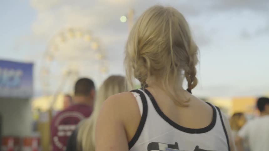 Girl watches carnival taking place in front of her