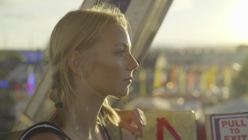Girl sits on a ride looking forward