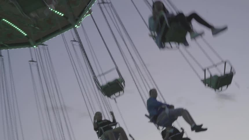 People on a swing ride at a festival