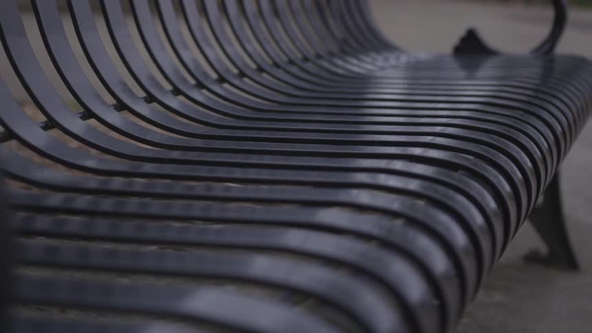 Black metal bench on ground