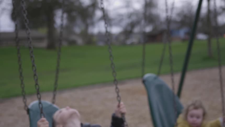 Child goes forward in a park swing