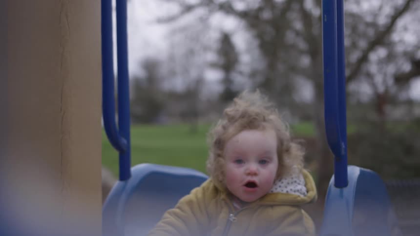 Child going down a toboggan on a playground