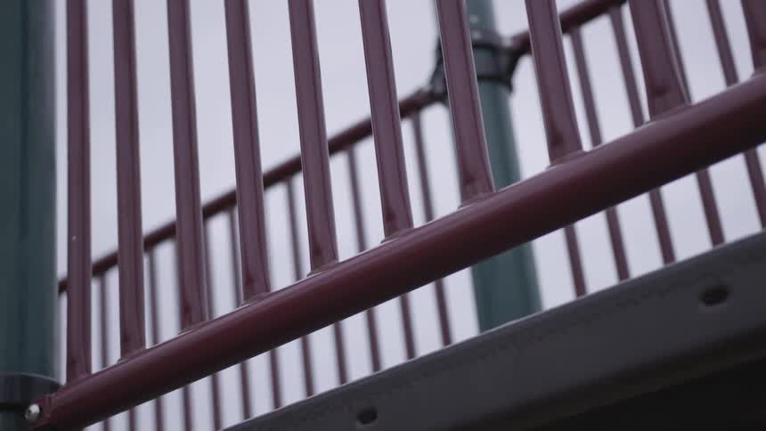 The camera looks a piece of playground equipment railing