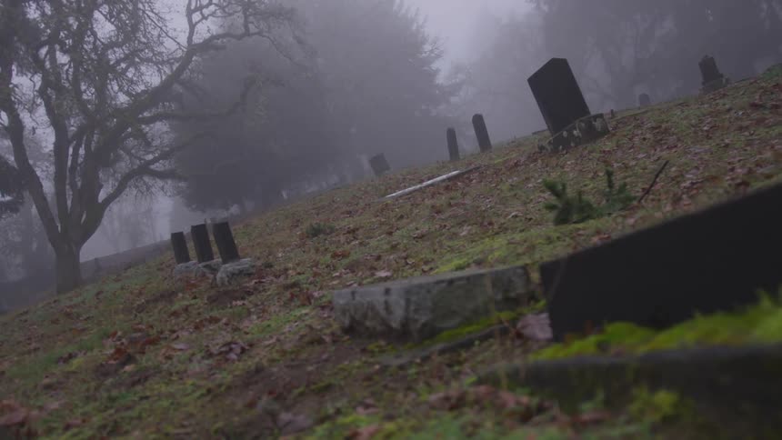 Fog rolling in over an abandoned cemetery