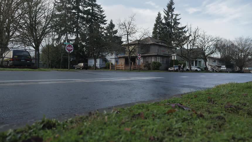 On a cloudy day traffic flows in a residential neighborhood