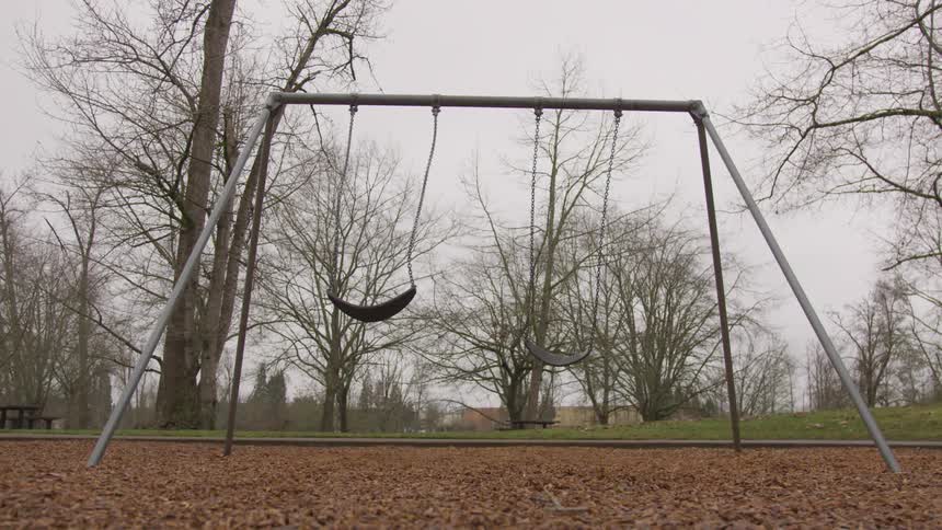 An empty swing set on a playground