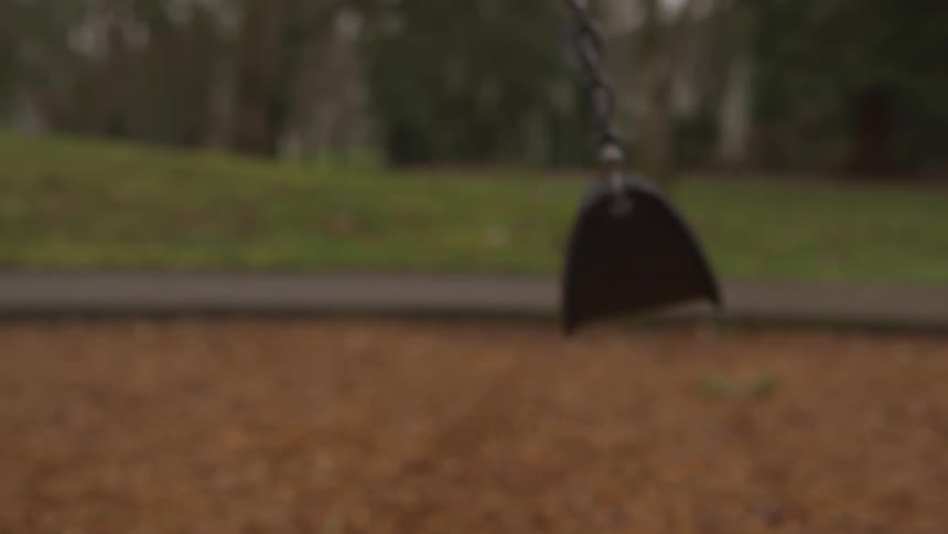 Swings swing on the playground by day
