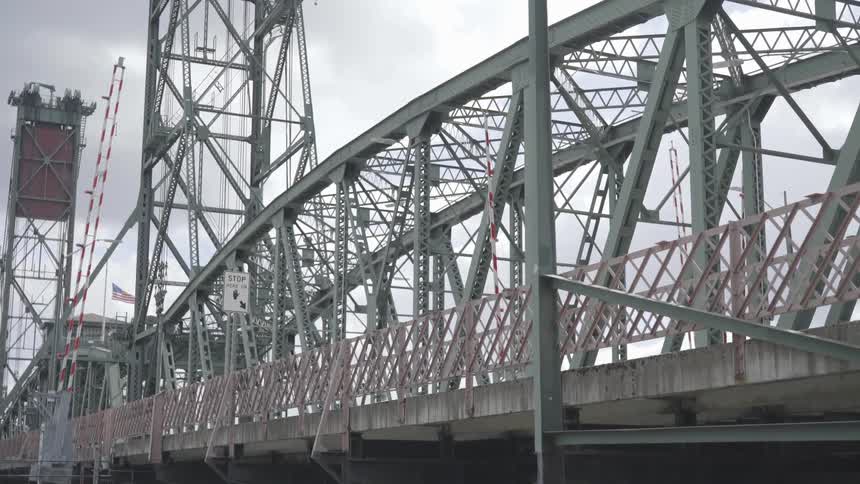 A car traveling on a steel bridge