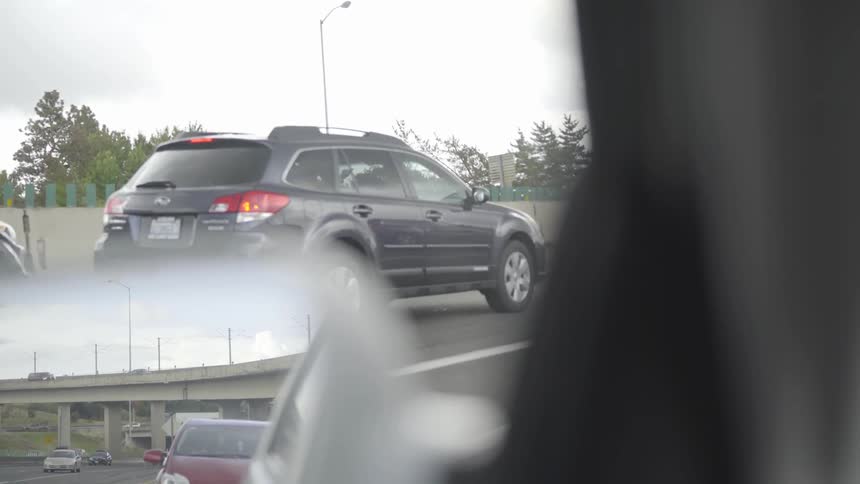 Cars are driving on a highway outdoors