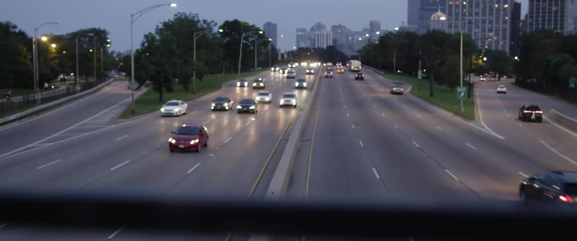 Cars on a highway speed under an overpass