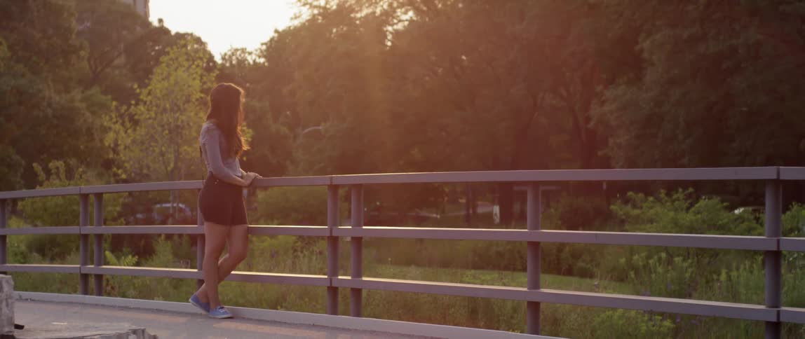 A person standing next to a railing