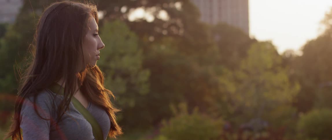 A woman looks around on a sunny day