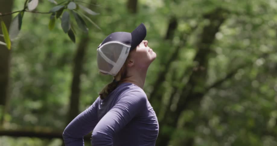 A woman standing in the woods