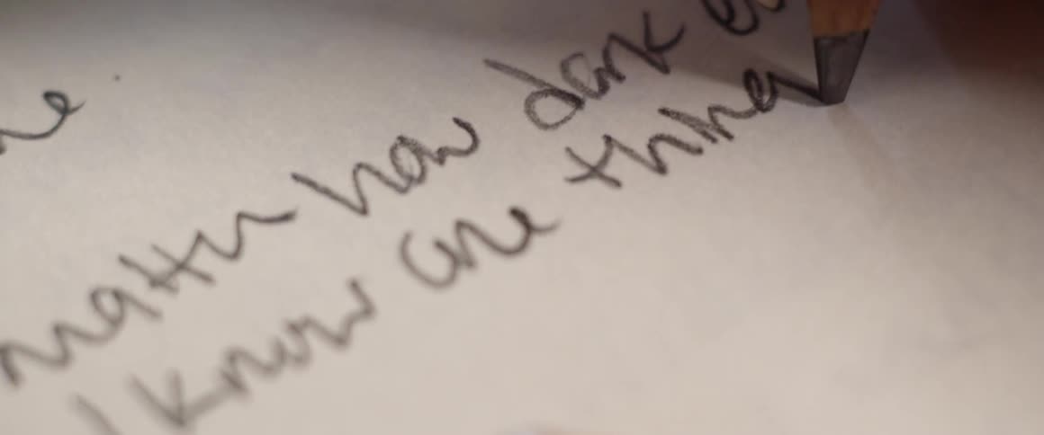 A person writing on paper
