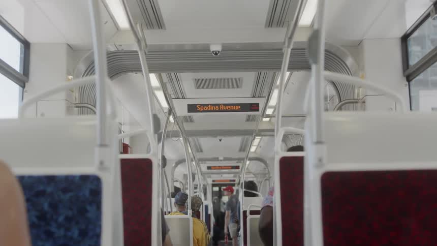 Camera looks down the aisle of a public transportation vehicle