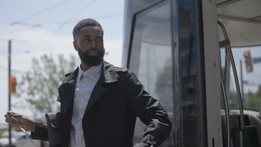 Man exits bus and others follow