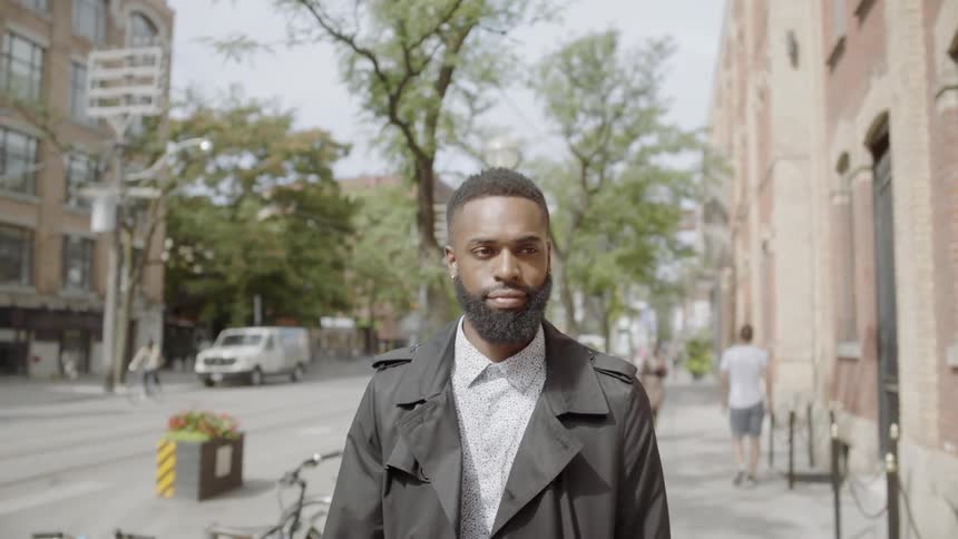 Black man strolling through downtown in the suburbs