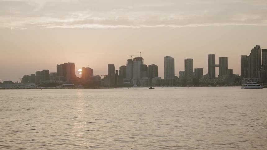 City skyline by a body of water with boats
