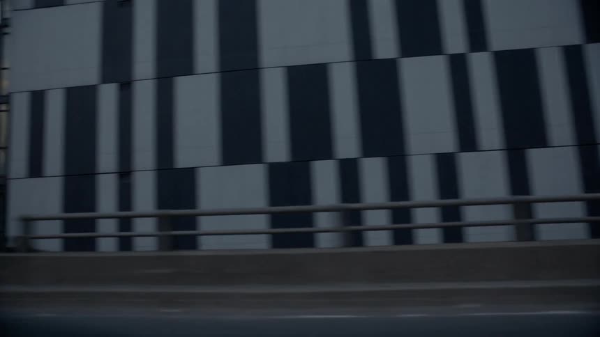 Panning shot of a city on the freeway