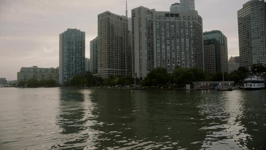 A downtown area with buildings is by the ocean