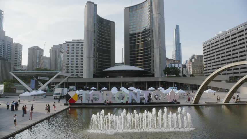 A water fountain in front of the city buildings