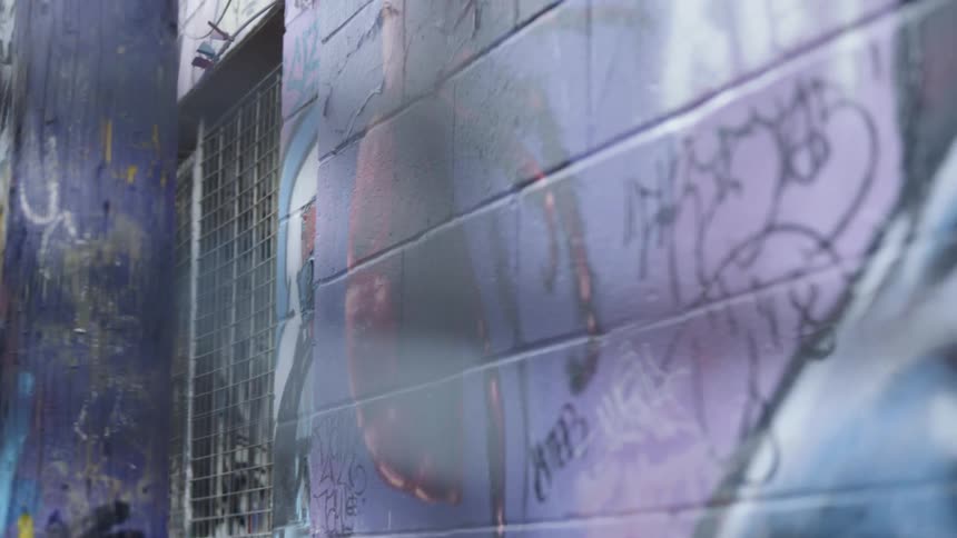 Graffiti on a wall and pole in daylight