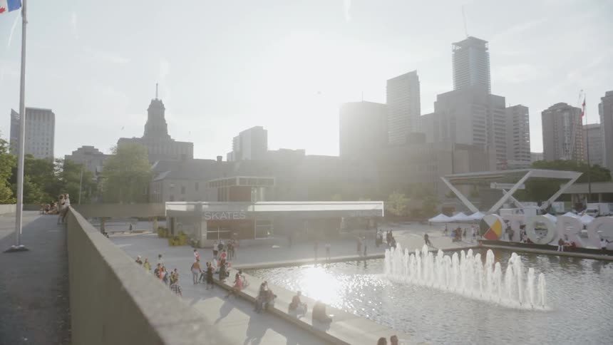 A busy skate park with a beautiful fountain
