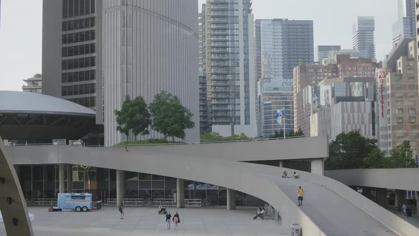 People walking on bridge and sidewalk in urban area