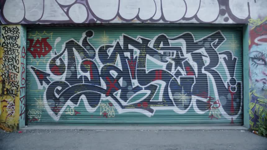 A roll down door that is covered in graffiti