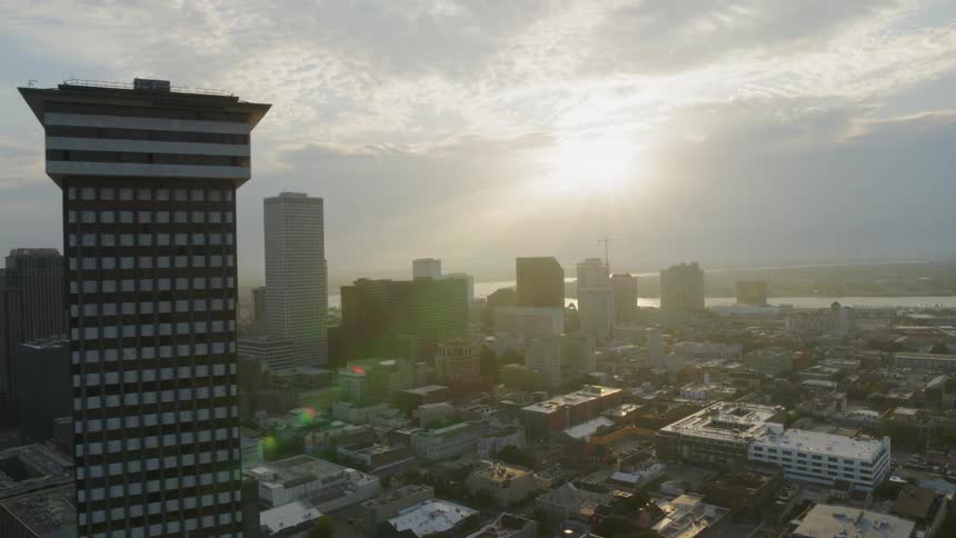 Tall buildings in a city sit under the bright sun