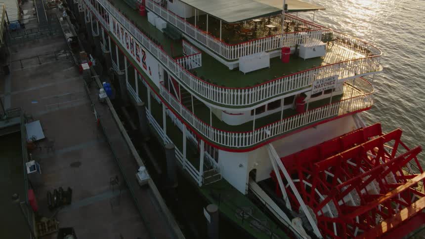 A large paddle steamboat at dock on the mississippi river