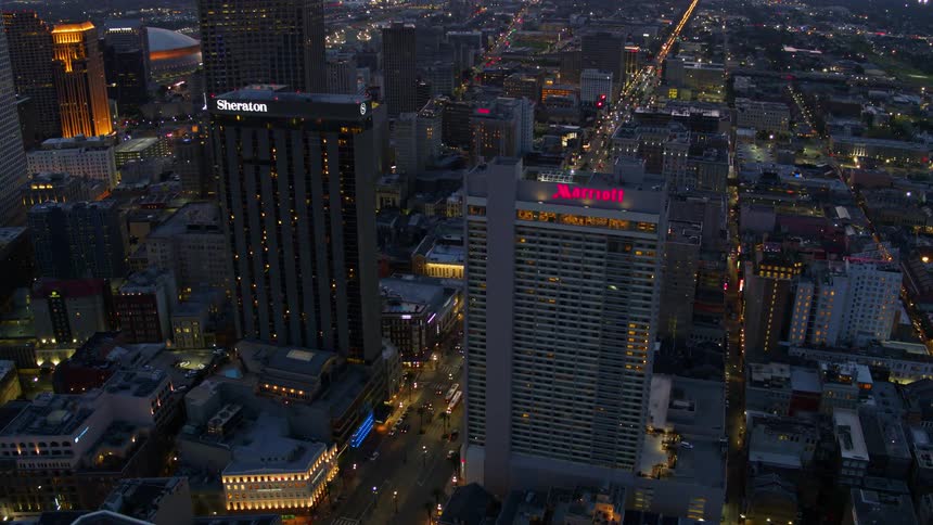 Aerial view of skyline at night with lights and road down the middle