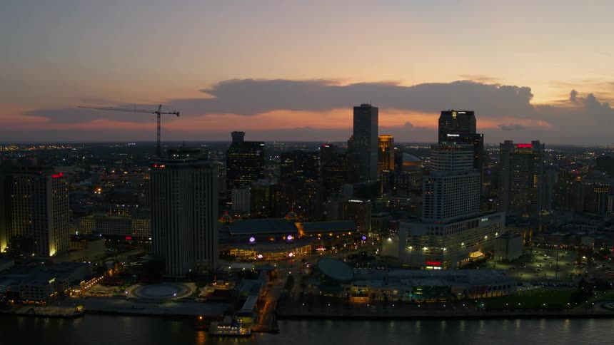 Skyline of a city near a body of water during the sunset