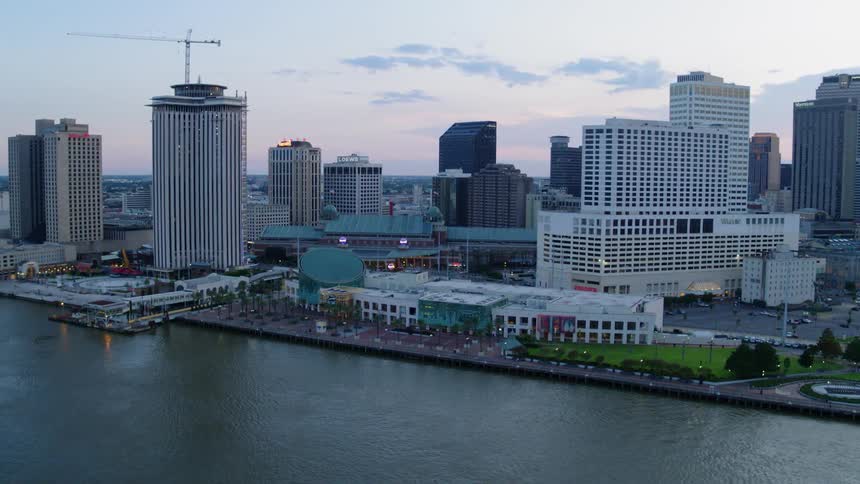 Skyscrapers stand in a city alongside an ocean