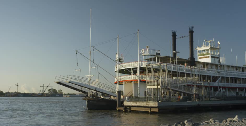 A large ship parked next to a smaller one