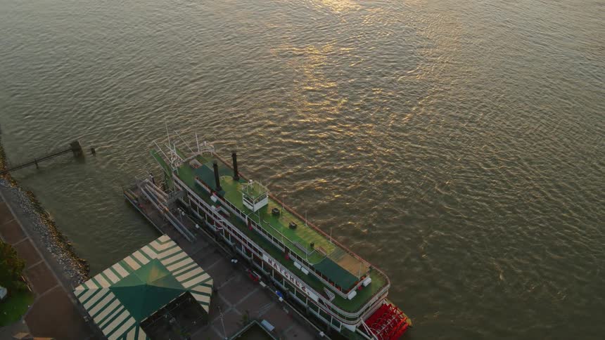 A ferry boat parked in water next to a dock
