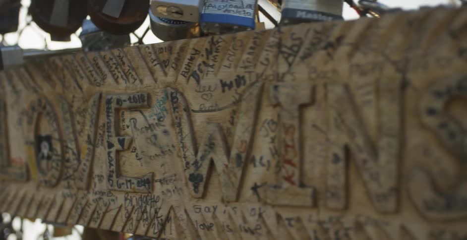 Love wins sign hangs with many locks