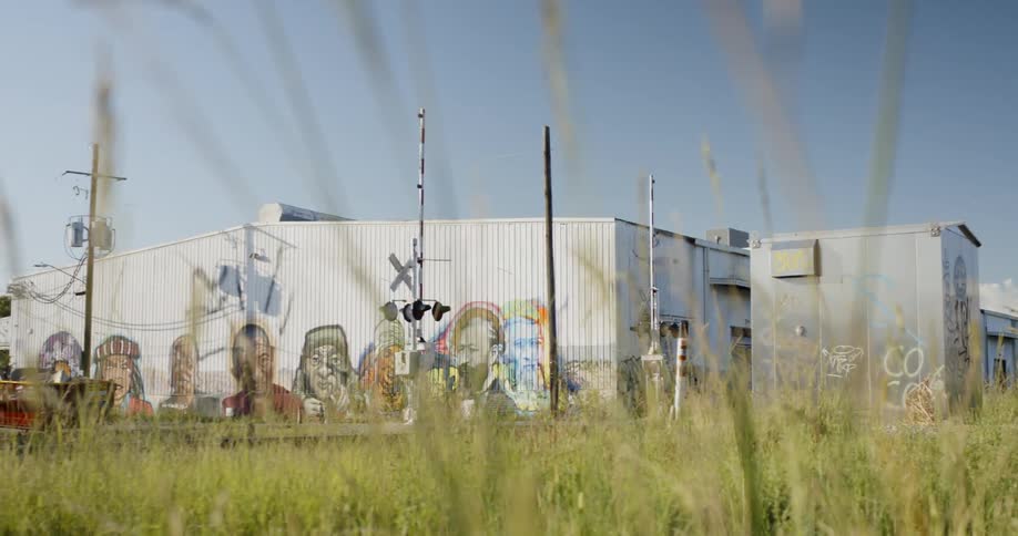 Graffiti on metal warehouses across the train tracks