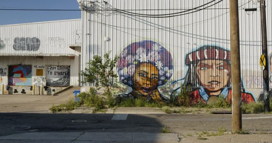 Graffiti adorns the side of a metal wall