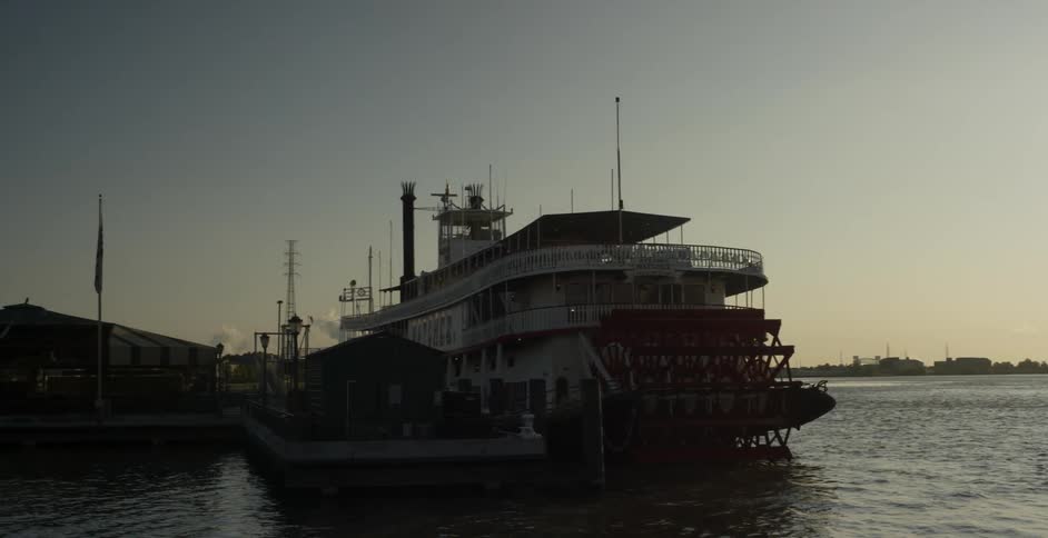 A ship is on the sea at sunset