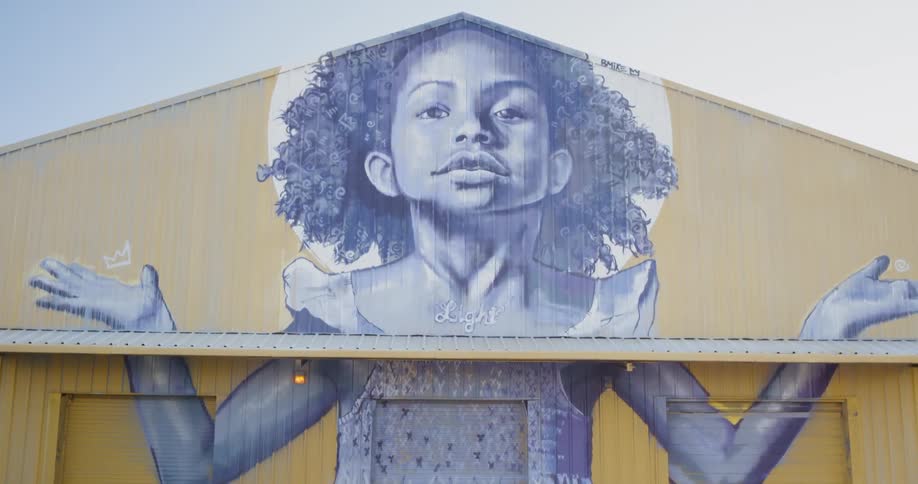 Picture of girl child on side of building